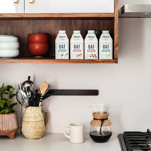 Elmhurst Shelf-Stable Oat Milk Coffee Creamer Varieties Sitting On a Shelf